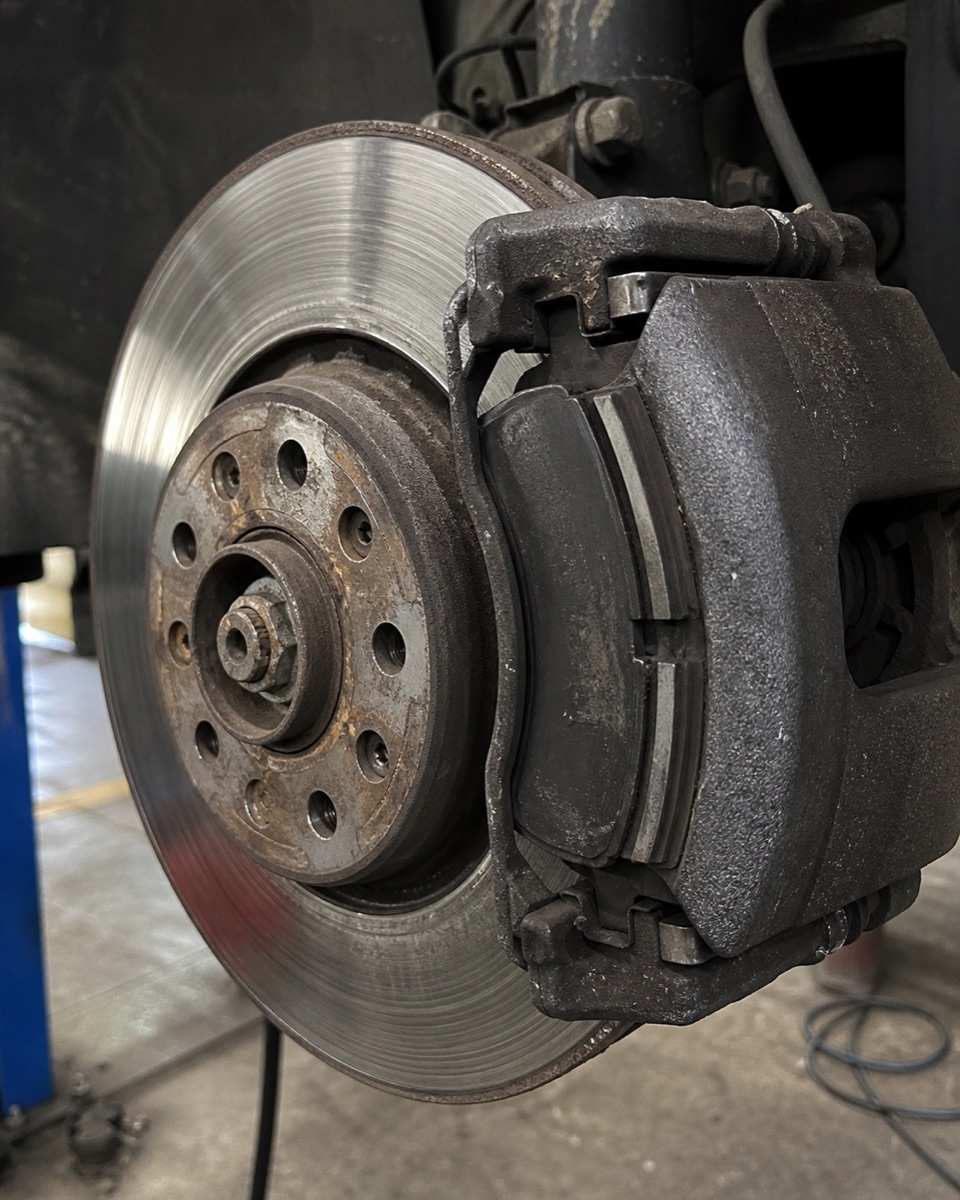 Brake disc, calliper and pads exposed with the wheel removed